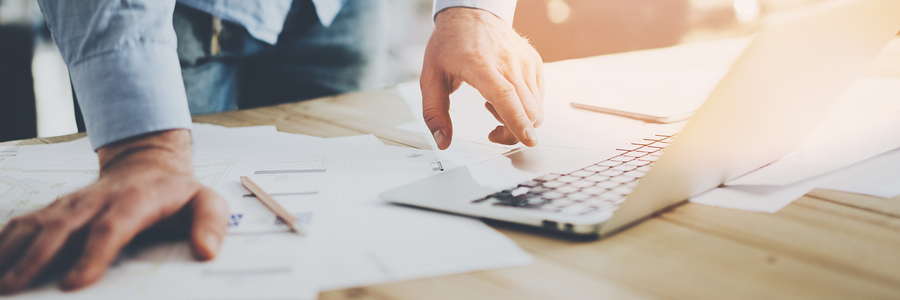 man conducting business on a messy table