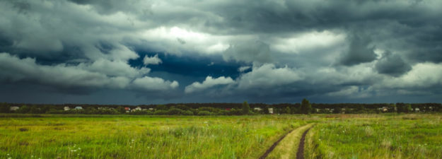 Dark Rain Storm Clouds Over The Field.