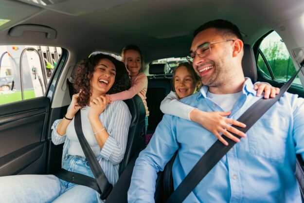 life-insurance-img Family enjoying a joyful car ride together, smiling and laughing inside a vehicle.